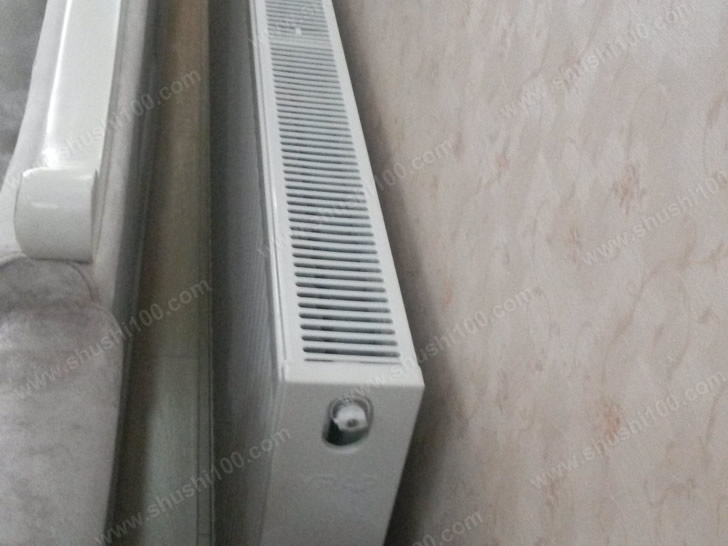 钢制板式暖气片安装效果图 暖气片与沙发之间预留了一定空间